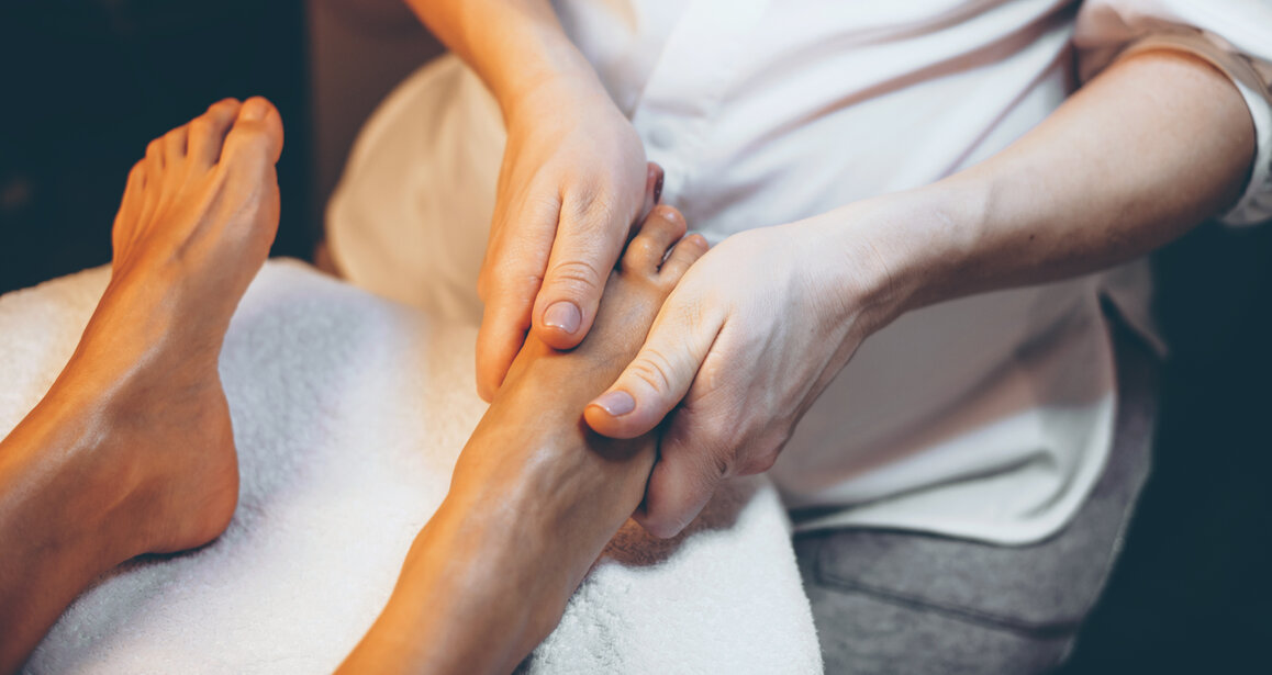 Relaxing Asian foot massage with the client seated comfortably